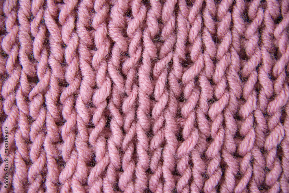 Pink knitted wool fabric close up, macro, background Pink knitted wool fabric close up, macro, background