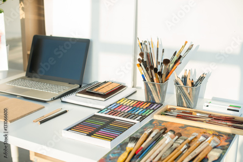 Painter workplace in order side view. Designer desk with drawing equipment. Home studio for artist