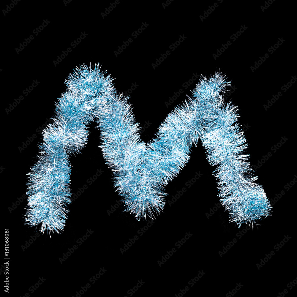 Festive alphabet made of blue tinsel. Letter M on black background. Isolated Festive alphabet made of blue tinsel. Letter M on black background. Isolated