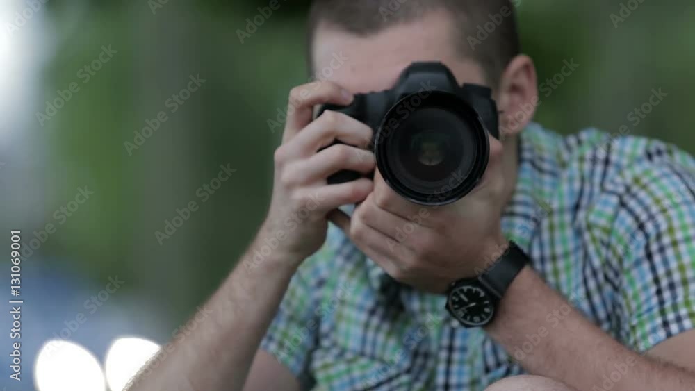 Young Man Taking Pictures At A Professional Digital Slr Camera Young Man Taking Pictures At A Professional Digital Slr Camera
