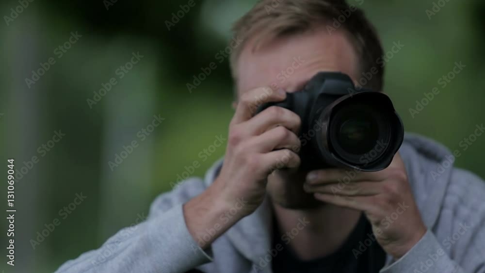 Young Man Taking Pictures At A Professional Digital Slr Camera Young Man Taking Pictures At A Professional Digital Slr Camera