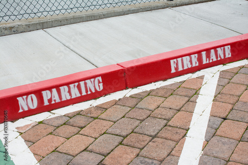 Painted red curb with no parking and fire lane