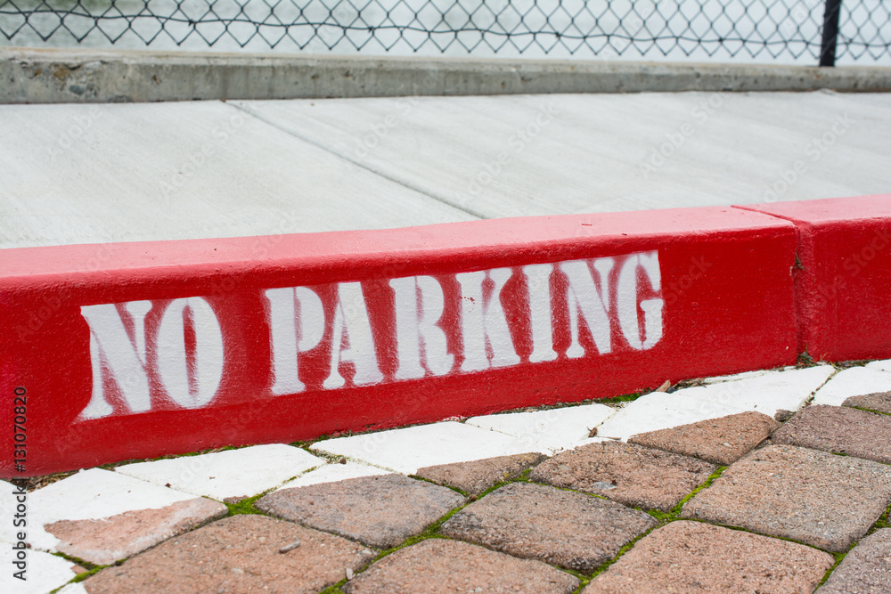 Foto Stock Painted red curb with no parking Adobe Stock