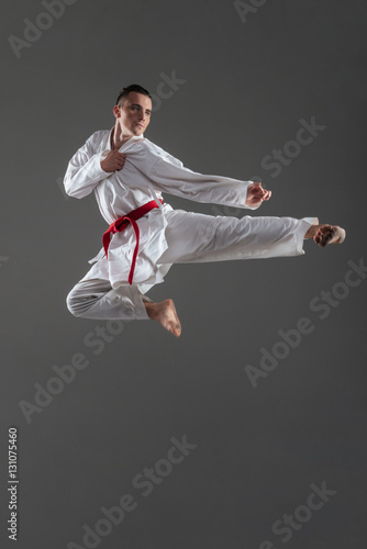 Handsome sportsman dressed in kimono practice in karate