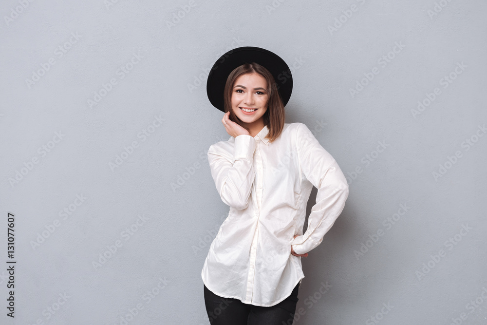 Portrait of a smiling woman in hat standing and posing Portrait of a smiling woman in hat standing and posing
