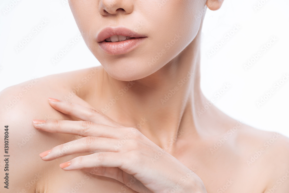 Graceful young Korean woman touching her skin Graceful young Korean woman touching her skin