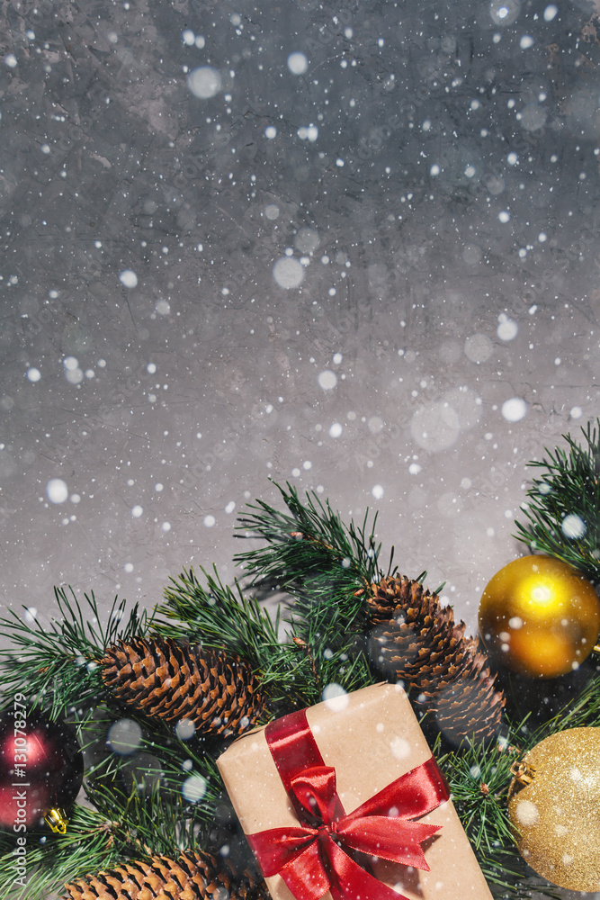 New Year's gift, toy, card, cones. New Year composition on gray concrete background. Snowflakes in the foreground. New Year's gift, toy, card, cones. New Year composition on gray concrete background. Snowflakes in the foreground.