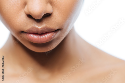 Peaceful young Negroid woman expressing emotions in the studio