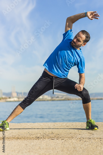 Runner stretching his body