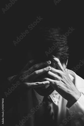 unhappy businessman, black and white. isolated on black