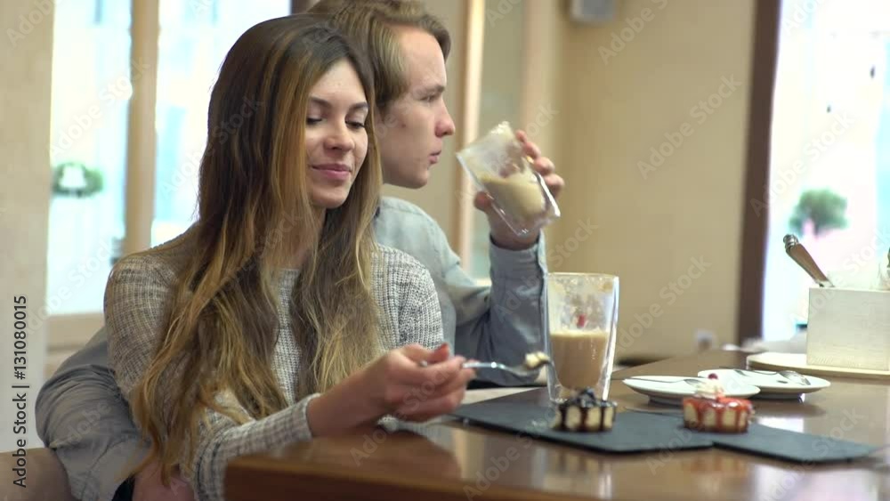 Student couple chatting together in a cafe Student couple chatting together in a cafe