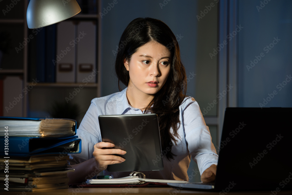 asian business woman use digital tablet working overtime asian business woman use digital tablet working overtime