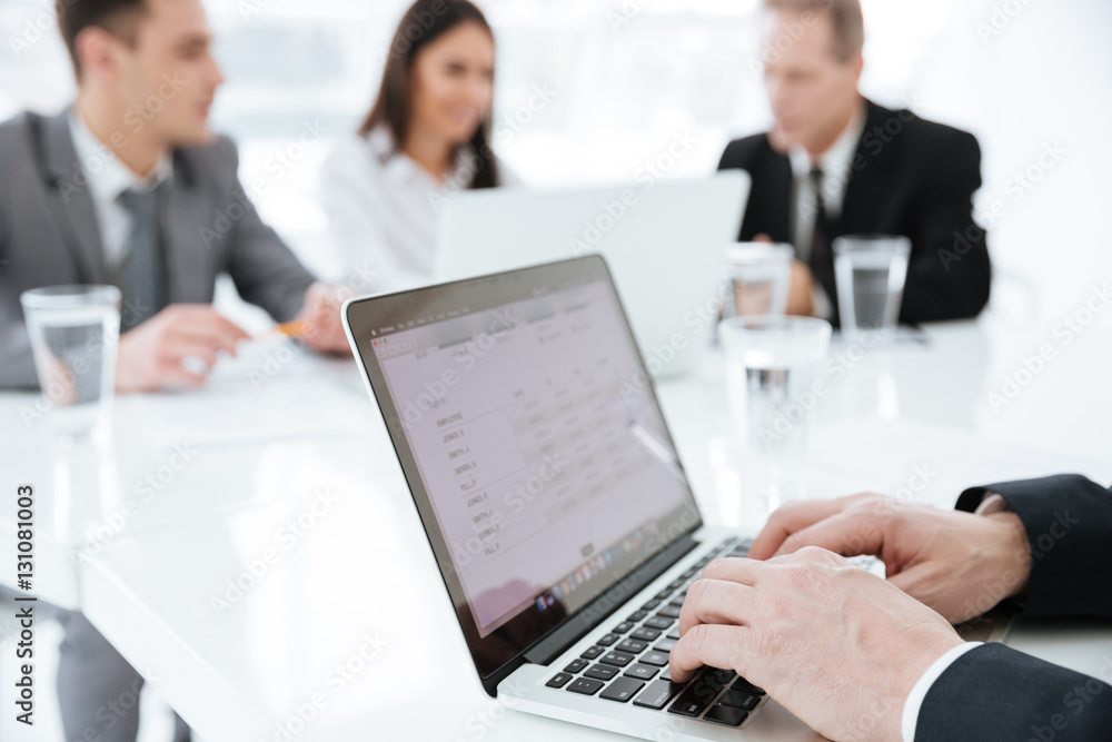 Cropped image Elderly business man by the table with partners Cropped image Elderly business man by the table with partners