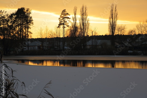 Winter sunset on the village pond. photo