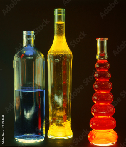 beautiful glass bottles filled with colored liquids