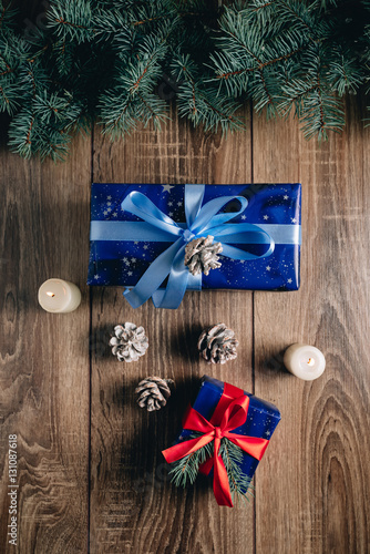 New Year composition View from above. Herringbone toys with candles, boxes on wooden background