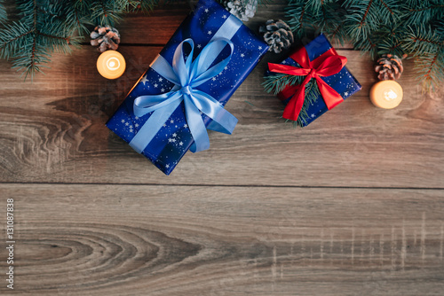 New Year composition View from above. Herringbone toys with candles, boxes on wooden background