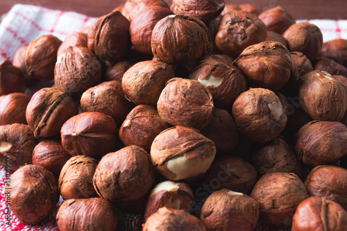 Hazelnuts pile on vintage kitchen dishcloth.