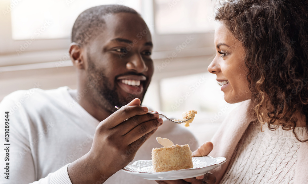 © Viacheslav Yakobchuk - Funny African American couple enjoying the dessert in the cafe