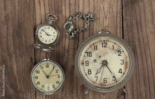 vintage watches, old alarm clock on a wooden background