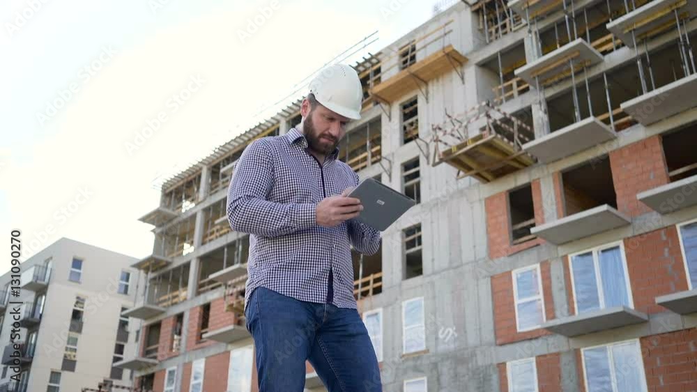 Architect browsing tablet at building place. Slider shot left.
Architect browsing tablet at building place. Slider shot left.