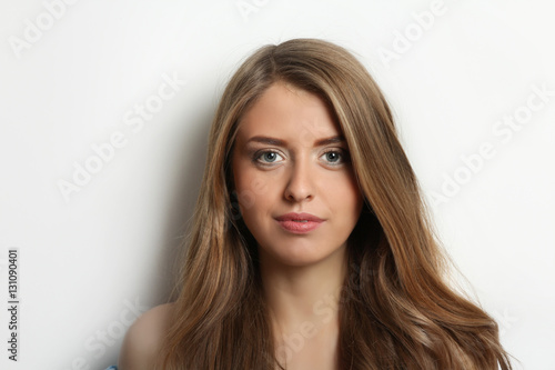 Beautiful girl with long wavy hair in the studio. Professional hair and make-up.