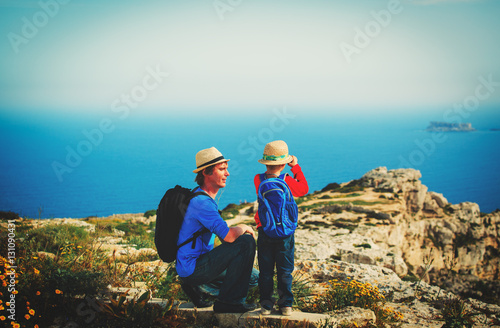 family travel -father and son hiking with backpack in mountains © nadezhda1906