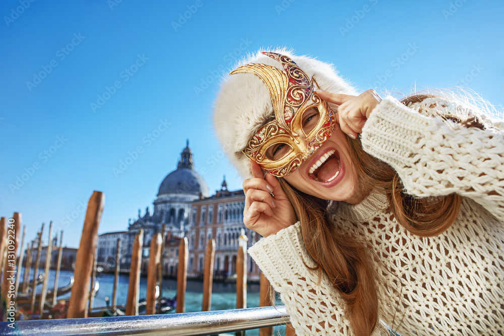 Fototapeta premium Portrait of happy woman in Venice, Italy wearing Venetian mask