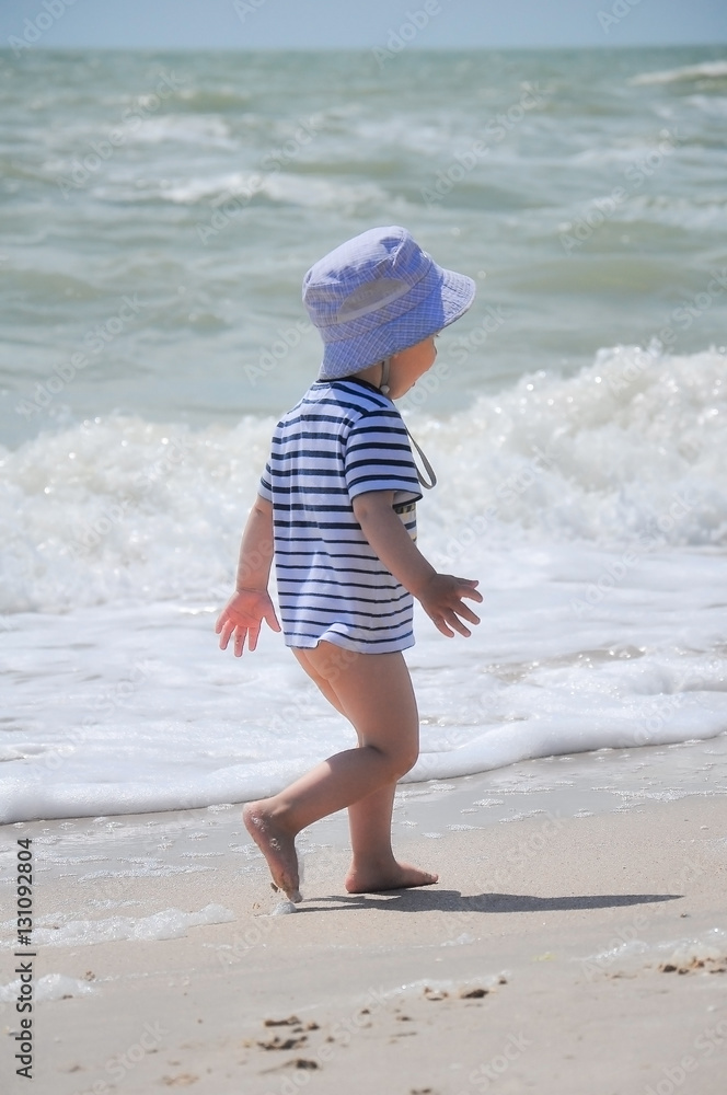 two-year-old boy run on the beach