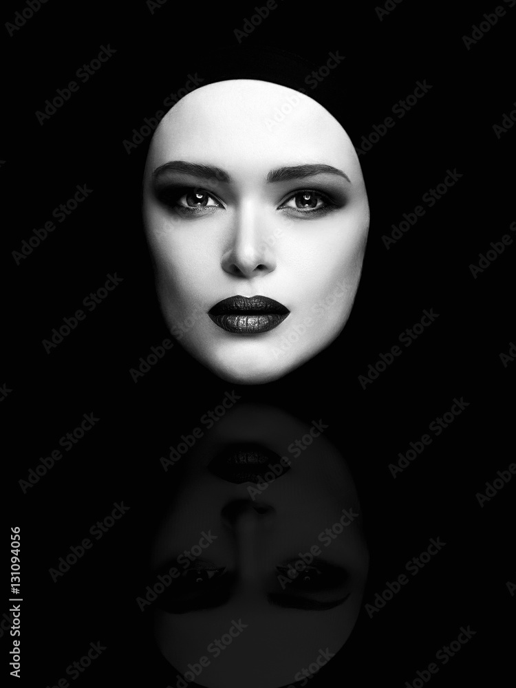 monochrome art fashion portrait of beautiful woman face like a mask. female head