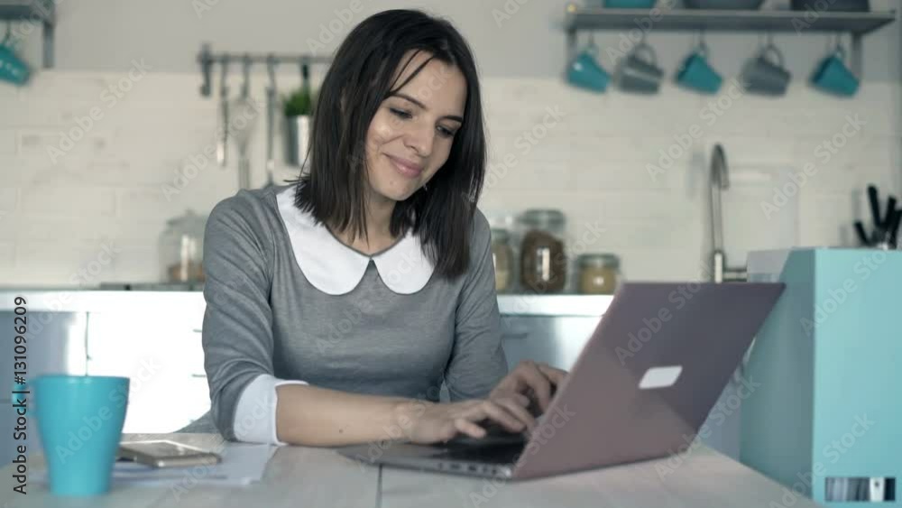 Young businesswoman working on laptop sitting by table in office
Young businesswoman working on laptop sitting by table in office