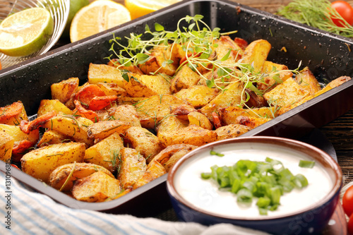 Fresh baked potatoes with herbs and white dip