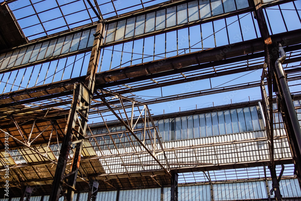 Industrial interior of an old factory building with blue sky Industrial interior of an old factory building with blue sky