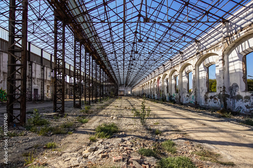Industrial interior of an old factory building with blue sky
