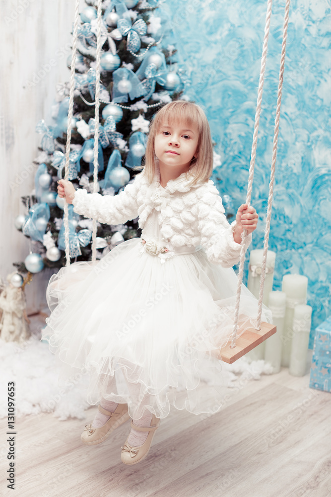little smiling girl near the Christmas tree little smiling girl near the Christmas tree