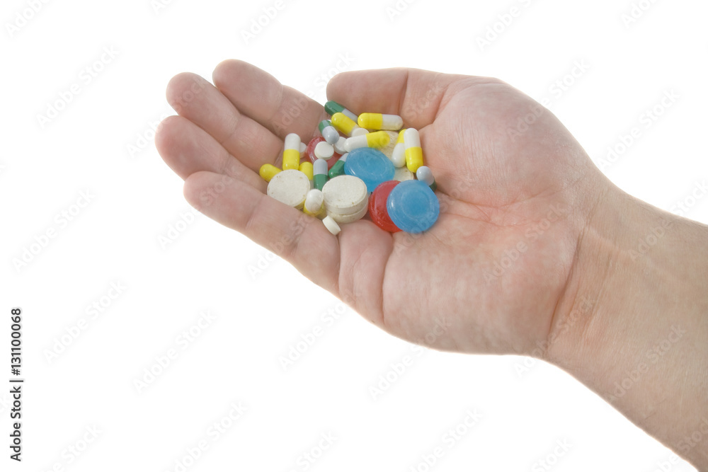 Closeup of vitamins and pills in human hands isolated over white Closeup of vitamins and pills in human hands isolated over white