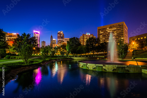 Fountain and lake at Marshall Park and the Uptown skyline at nig