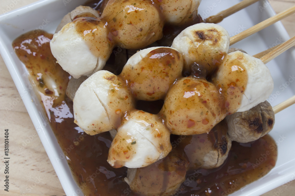 Pork meatballs on white plate placed on a wooden floor. Pork meatballs on white plate placed on a wooden floor.