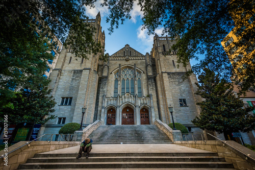 Man sitting on the steps of First United Methodist Church, in Up