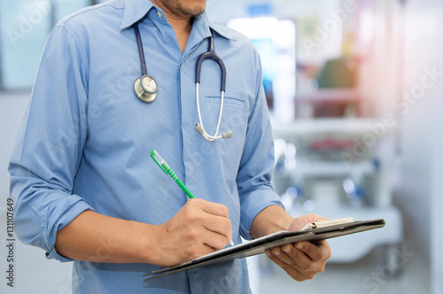 Doctor writing a medical prescription in hospital