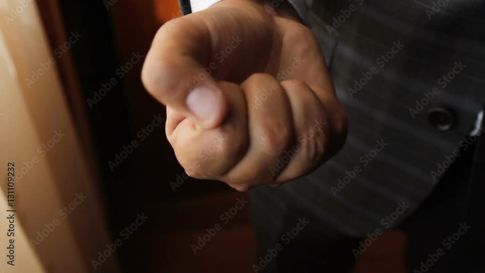a man squeezes two wedding rings in a hand a fist