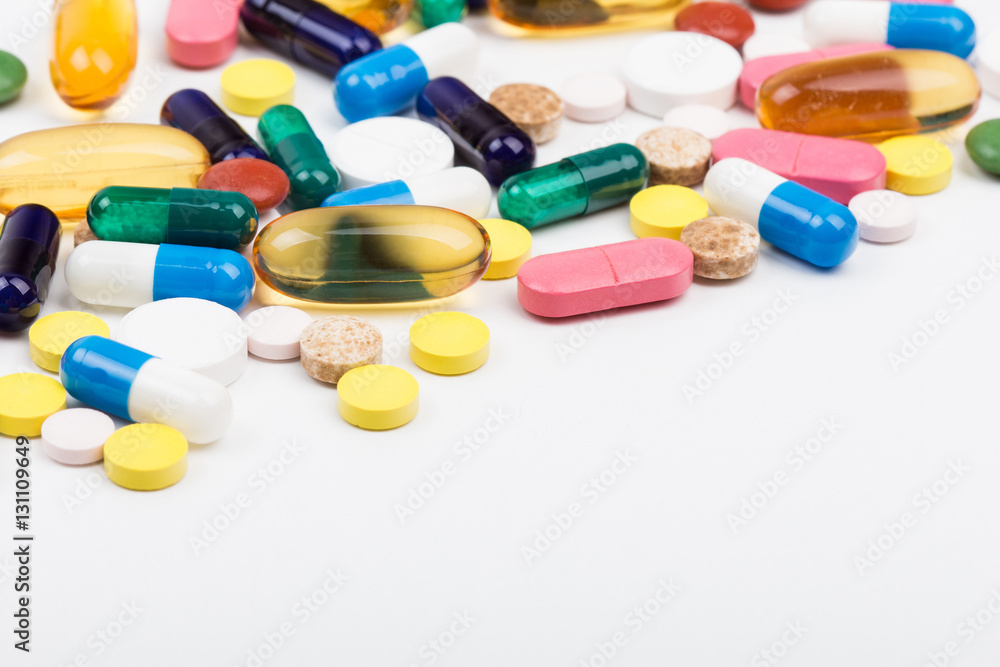 Bunch of pills and capsules on white Bunch of pills and capsules on white