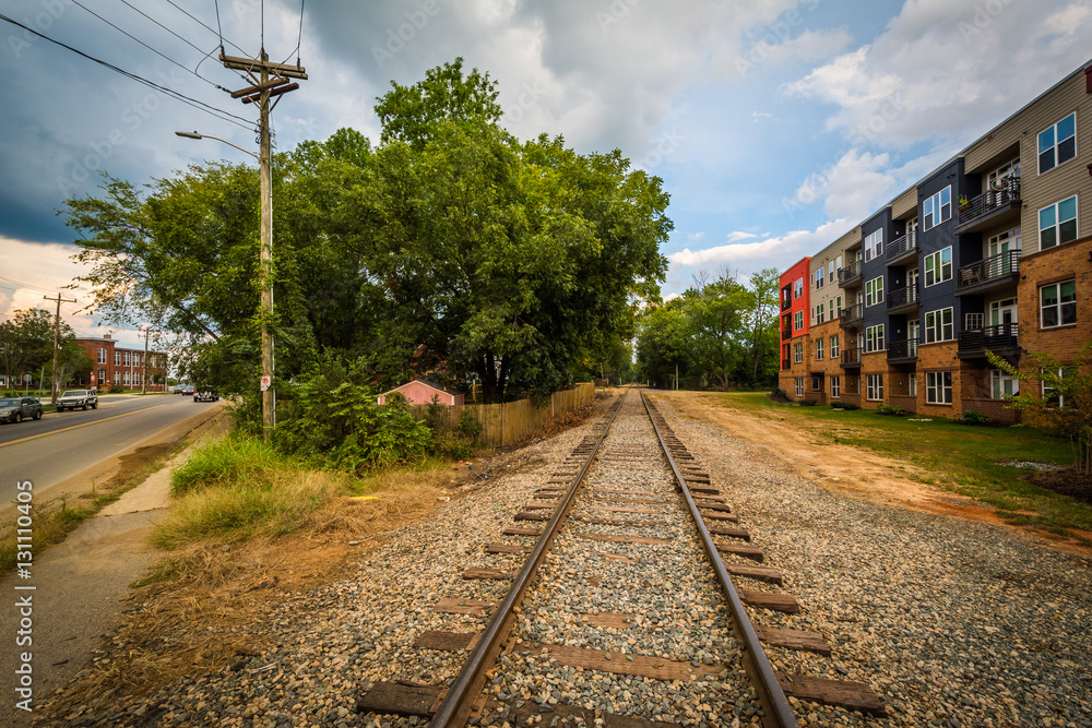 Fototapeta premium Railroad tracks and buildings, in NoDa, Charlotte, North Carolin