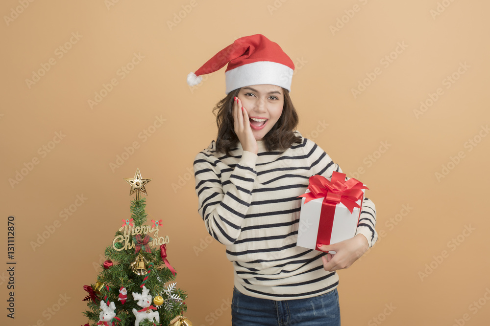 Beautiful christmas girl in santa hat with boxes on autumn back Beautiful christmas girl in santa hat with boxes on autumn back