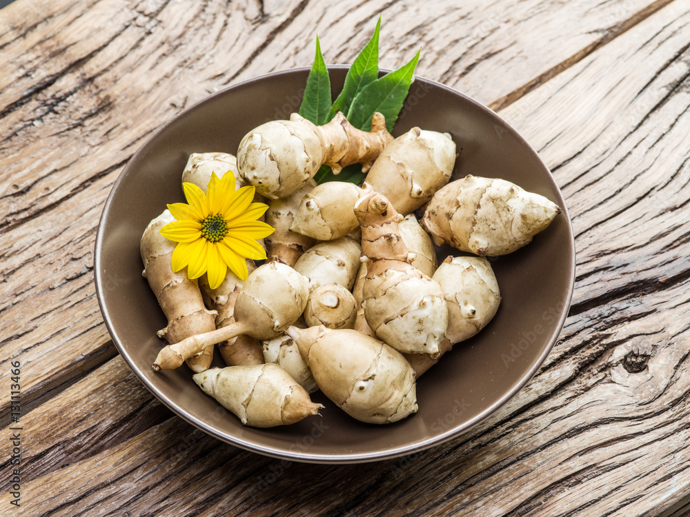 Fototapeta premium Jerusalem artichoke on wooden table.
