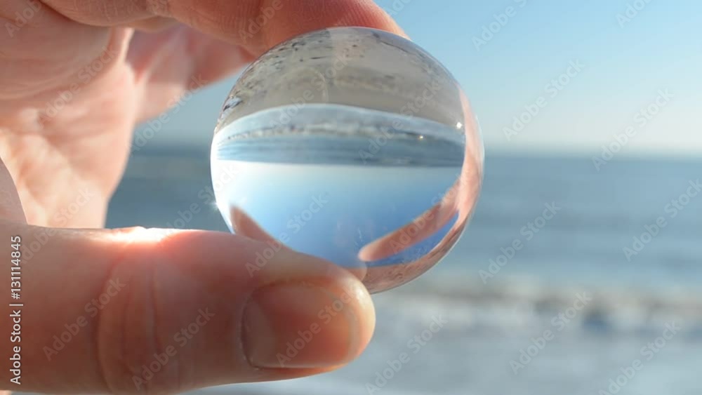Shooting through a crystal sphere. Shooting on the sea beach. Shooting through a crystal sphere. Shooting on the sea beach.