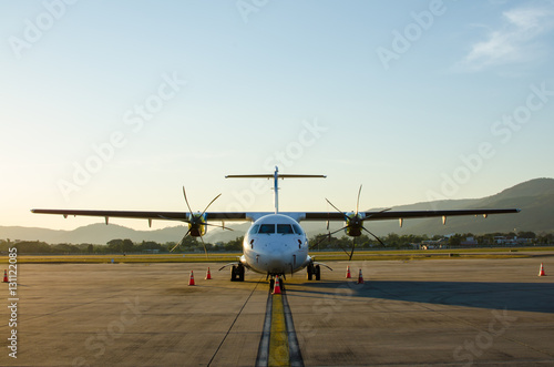 Small Airplane or Aeroplane Parked at Airport.Small Airplane Famous to use Private Airplane.Sunset Light and Mountain View.