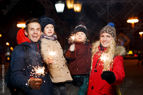 Happy family with burning sparklers