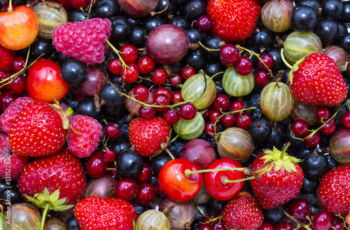 Berry background with fresh raspberries  blueberries  currants  strawberries  cherries 