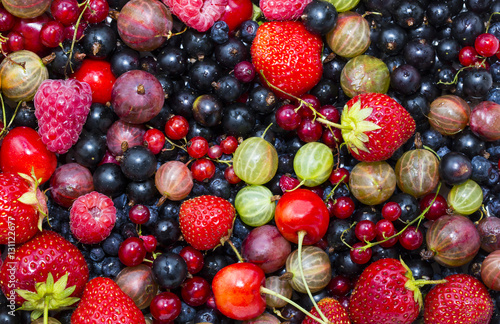 Berry background with fresh raspberries, blueberries, currants, strawberries, cherries,